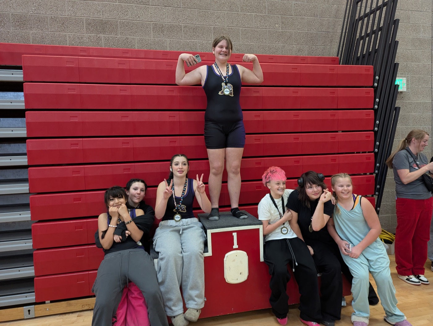Cottonwood girls wrestlers celebrating with their medals